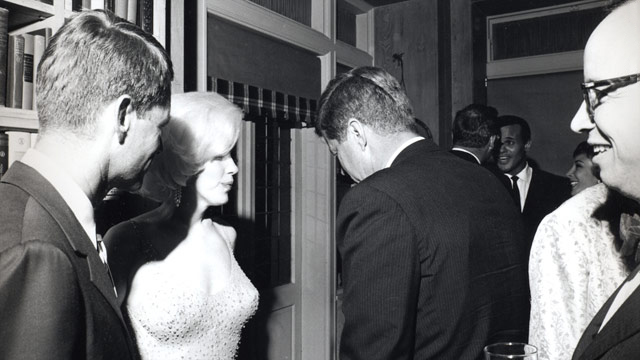 Marilyn Monroe speaks to US President John F. Kennedy.  